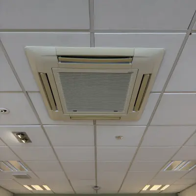 Ceiling view in an empty office space with tiled panels and ceiling air conditioning at Buikslotermeerplein 430, Amsterdam North.