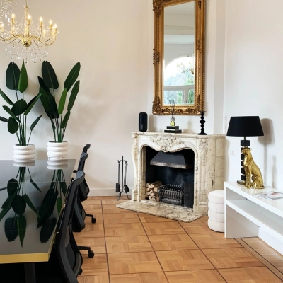 Elegant office space available for rent in Amsterdam Old South, featuring a stylish conference table, decorative fireplace, and chic furnishings at Emmalaan 7-9.