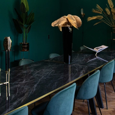 Furnished office space with a long marble table and teal chairs, located at Emmalaan 7-9. Ideal for office space rental in Amsterdam Old South.