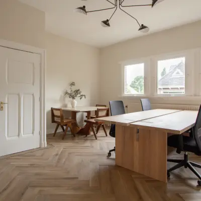 Bright furnished office space rental at Emmalaan 7-9, featuring natural light and a stylish meeting area. Ideal office to rent in Amsterdam Old South.