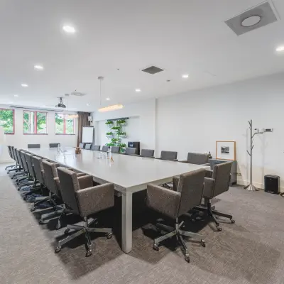 Spacious conference room with a long table and chairs in an office space available for rent at Olympisch Stadion 24-28, Amsterdam Old South.