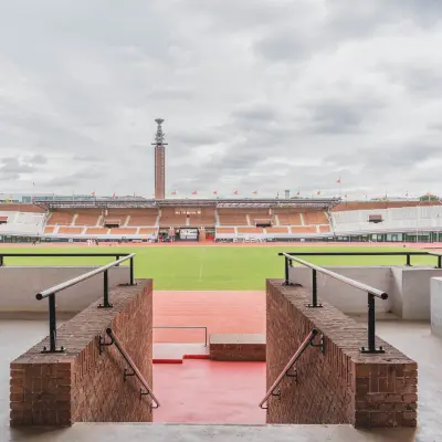 A view from the Olympisch Stadion in Amsterdam Old South, showcasing expansive seating and a wide field, ideal for various events.