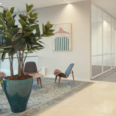 Spacious office entrance at David Ricardostraat 1 in Amsterdam Riekerpolder, featuring modern furnishings and vibrant decor. Ideal office space rental with comfortable seating area.