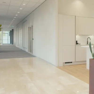 Bright and modern office to rent in Amsterdam Riekerpolder with stylish plants and a tidy kitchenette. Ideal for office space rental needs.