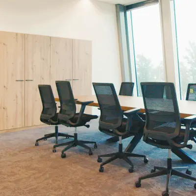 Modern workspace available for rent at David Ricardostraat 1, Amsterdam Riekerpolder, featuring a long table and ergonomic chairs, suitable for meetings and team collaborations.