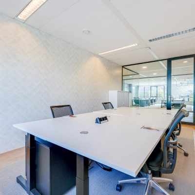 Bright and modern office space with a large meeting table and chairs, ideal for office space rental at Thomas R. Malthusstraat, Amsterdam Riekerpolder.