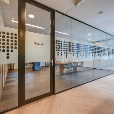Modern office space with glass walls, featuring stylish conference rooms available for office space rental in Amsterdam Riekerpolder, Thomas R. Malthusstraat 1-3.
