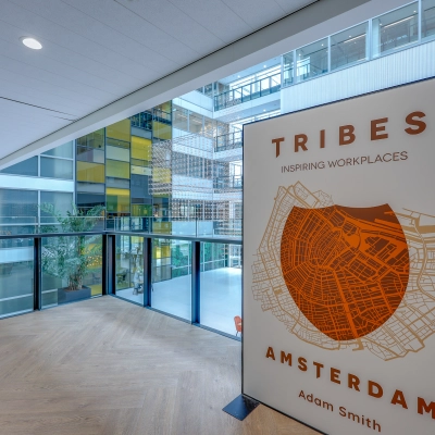 Modern interior with a large window showcasing an office building at Thomas R. Malthusstraat 1-3, a prime office space rental in Amsterdam Riekerpolder.