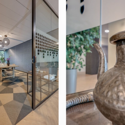 A modern conference room with a large table, stylish lighting, and a decorative pitcher in the foreground, perfect for office space rental in Amsterdam Riekerpolder.