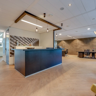 Modern office space for rent at Thomas R. Malthusstraat 1-3, Amsterdam Riekerpolder, featuring a stylish reception area with a sleek desk and contemporary furnishings.