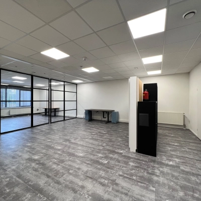 A well-lit office space with modern flooring and glass-partitioned area at Contactweg 131, Amsterdam Sloterdijk, available for rent.