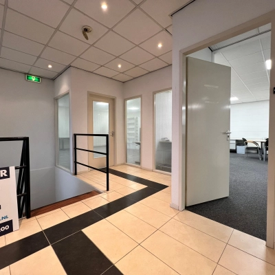 Interior view of office space available for rent at Contactweg 131 in Amsterdam Sloterdijk, featuring multiple open doors and tiled flooring.