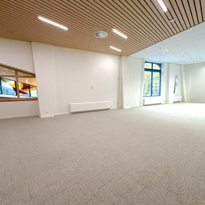 Spacious, well-lit office space available for rent at Bijlmerplein 888, Amsterdam South East, featuring large windows and modern ceiling lights.