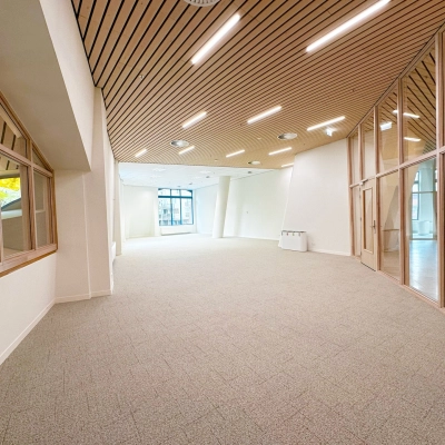 Spacious and modern office space at Bijlmerplein 888 in Amsterdam South East, featuring large windows and wooden ceiling accents, ideal for rent office space.