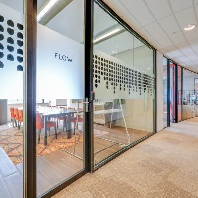 Interior view of an office space located at De Entree 99-197 in Amsterdam South East, featuring glass walls and modern decor, ideal for office space rental.