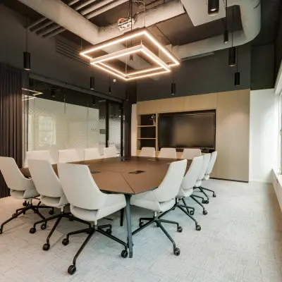 Modern conference room at Herikerbergweg 288, Amsterdam South East, offering office space rental with sleek chairs and ample lighting.