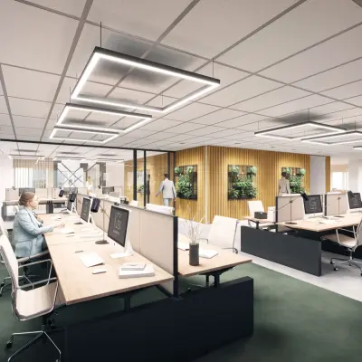 Modern office space in Amsterdam South East with workstations and greenery, suitable for rent. Professionals are engaged in work activities.