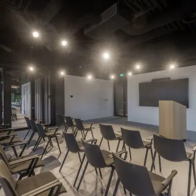 Conference room at Herikerbergweg 290 in Amsterdam South East featuring rows of chairs and a podium, ideal for office space rental.