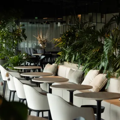 Modern office space with elegant furnishings, plants, and comfortable seating located at Herikerbergweg 290, Amsterdam South East, available for office space rental.