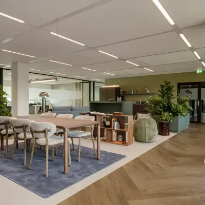 Spacious furnished office at Herikerbergweg 290, Amsterdam South East, features plants and modern furniture, ideal for office space rental.