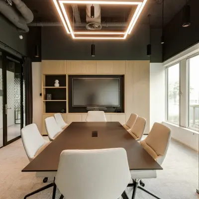Modern conference room in Amsterdam South East with sleek lighting and a large table, ideal for office space rental.