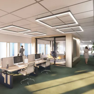 Modern office space at Herikerbergweg 290, Amsterdam South East, featuring workstations and a meeting room with people engaged in business activities.