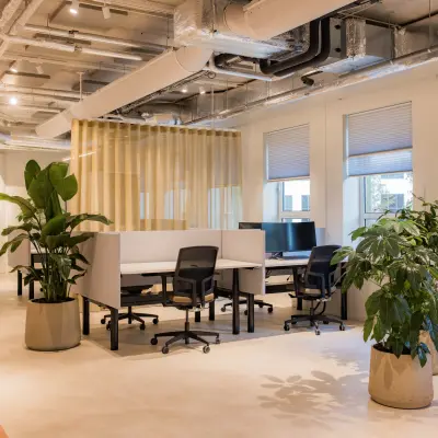 Bright office space with modern decor, featuring desks, chairs, and lush plants at Hullenbergweg 109-135 in Amsterdam South East, available for rent.