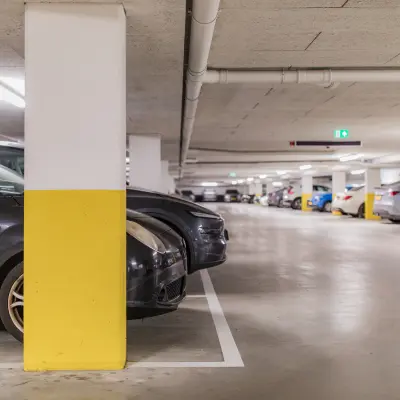 Underground parking area at Hullenbergweg 109-135, Amsterdam South East, with several cars parked and clear signages.