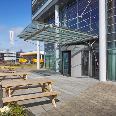 Exterior view of modern office building at Laarderhoogtweg with outdoor seating in Amsterdam South East, ideal for office space rental.