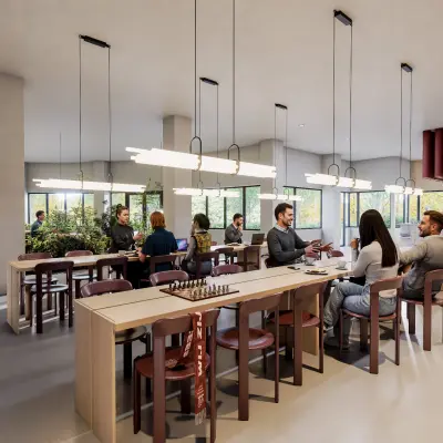 Spacious and modern workspace at Luttenbergweg 8, Amsterdam South East. People are engaged in business discussions around large wooden tables in a well-lit, furnished environment, ideal for office space rental.