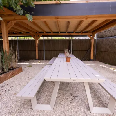 Outdoor seating area under a wooden pergola at Luttenbergweg 8, ideal for office space rental in Amsterdam South East.