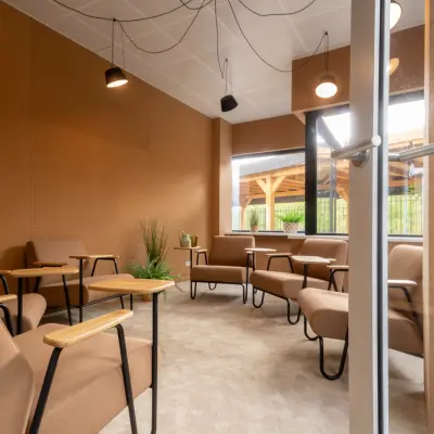Cozy office space with modern furnishings at Luttenbergweg 8, Amsterdam South East, available for rent. Comfortable seating and natural lighting create a welcoming environment.