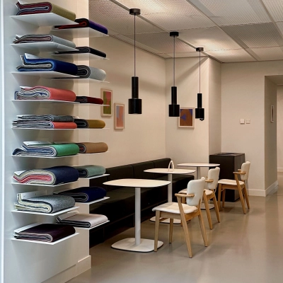 Modern office space in Amsterdam West featuring a furnished seating area with tables and chairs, ideal for office space rental.