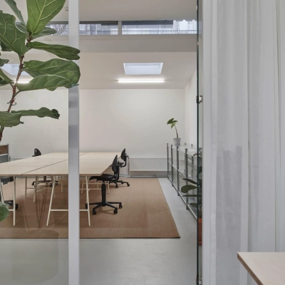 Modern office space with minimalist design at Hondiusstraat 7H, Amsterdam West. Features include sleek desks, contemporary chairs, and natural lighting, ideal for office space rental.