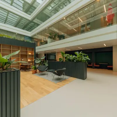 Modern office space available for rent at Kon. Wilhelminaplein 4, Amsterdam West. Spacious open floorplan adorned with greenery and natural light. Ideal for office space rental.