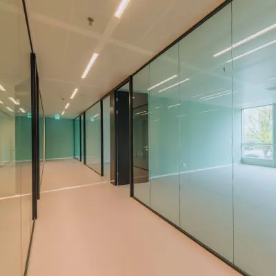 Spacious office space at Kon. Wilhelminaplein 4, Amsterdam West with glass partitions and natural light, ideal for office space rental.