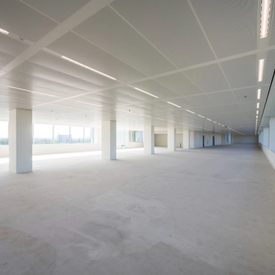 Office space for rent at Nachtwachtlaan 20, Amsterdam West. Spacious, unfurnished interior with large windows providing natural light, ideal for various office setups.