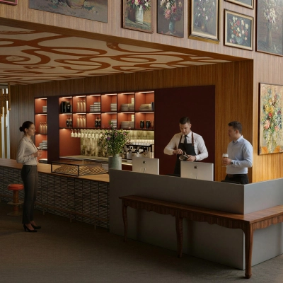Spacious office to rent at Barbara Strozzilaan 101 101, Amsterdam Zuidas, featuring a stylish coffee bar with professionals engaged in discussions and work activities.