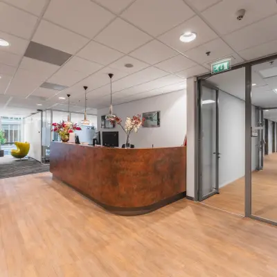 Spacious office reception at Claude Debussylaan 10, features modern furniture and large windows, ideal for office space rental in Amsterdam Zuidas.
