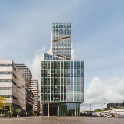 Modern office building at Claude Debussylaan 10, Amsterdam Zuidas, with a striking glass facade ideal for office space rental.