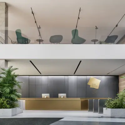 Modern reception area at Claude Debussylaan 80-134, Amsterdam Zuidas, perfect for office space rental with stylish furnishings and lush greenery.