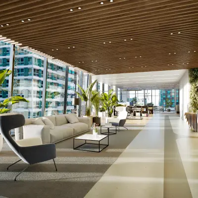 Modern, furnished office space with large windows, offering a vibrant view in Amsterdam Zuidas. Ideal for those looking to rent office space with a comfortable lounge area and abundant natural light.