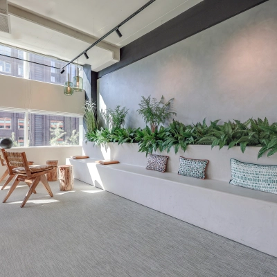 Bright, modern office space rental at Gustav Mahlerlaan 308, Amsterdam Zuidas, featuring a stylish, furnished interior with seating and greenery.