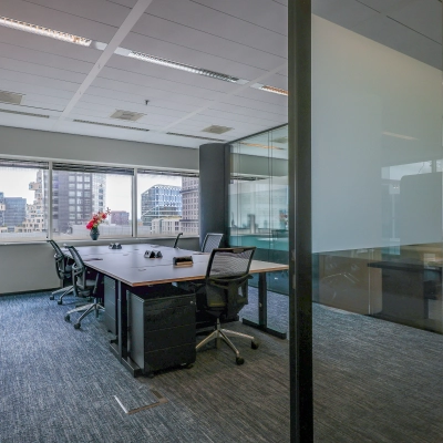 Modern office space at Gustav Mahlerplein in Amsterdam Zuidas, featuring a furnished interior with desks and chairs, available for rent.