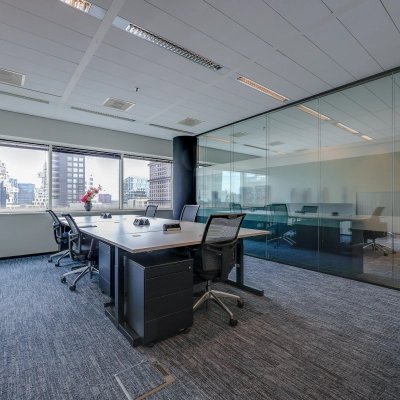 Modern office space with large windows, furnished with sleek desks and chairs, located at Gustav Mahlerplein in Amsterdam Zuidas, ideal for rent office space.