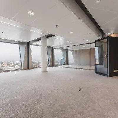 Spacious office space at Hildegard Von Bingenstraat 44 in Amsterdam Zuidas, featuring large windows and neutral decor, ideal for office space rental.