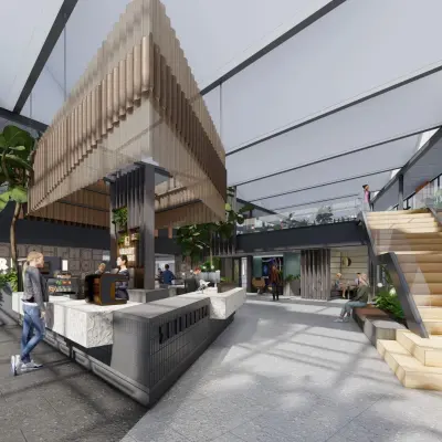 Modern office space at Jachthavenweg 109, Amsterdam Zuidas with seating areas, café, and people working. Ideal for office space rental in a vibrant environment.