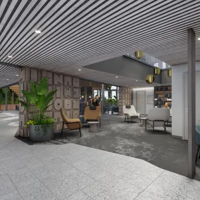 Modern office space rental at Jachthavenweg 109, Amsterdam Zuidas, featuring stylish seating areas and people engaged in discussions and work activities.