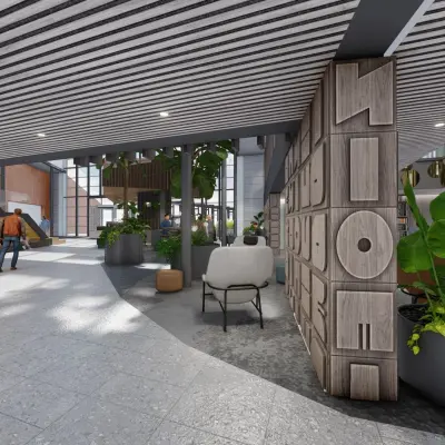Modern office space in Amsterdam Zuidas with stylish decor and greenery, featuring a man walking. Ideal for rent, offering a dynamic environment for professionals.