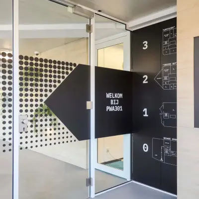 Entrance of an office to rent at Prins Willem-Alexanderlaan 301, Apeldoorn, featuring modern design and directional signage.